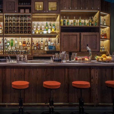 Craft Cocktail Bar with orange bar stools