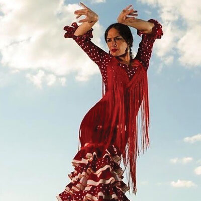 Flamenco Dancer in a red dress on a background of the sky