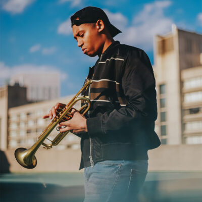Photo of Alonzo Demetrius holding his trumpet