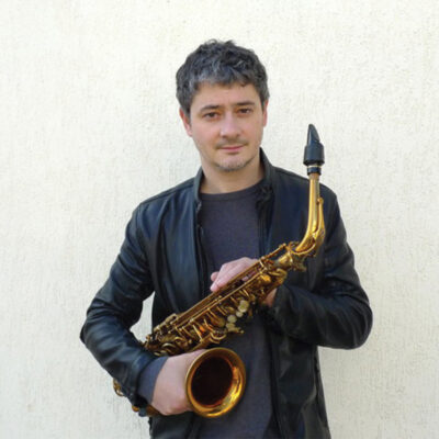 Portrait of musician Dmtry Baevsky holding his saxaphone