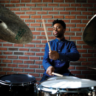 Headshot of Jonathan Barber playing the drums