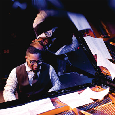 Headshot of Keith Brown playing on the grand piano