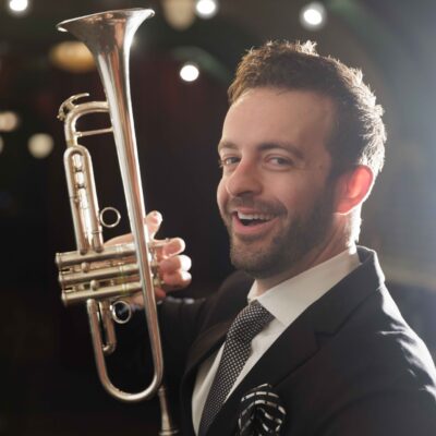 Musician Benny Benack holding trumpet in The Django.