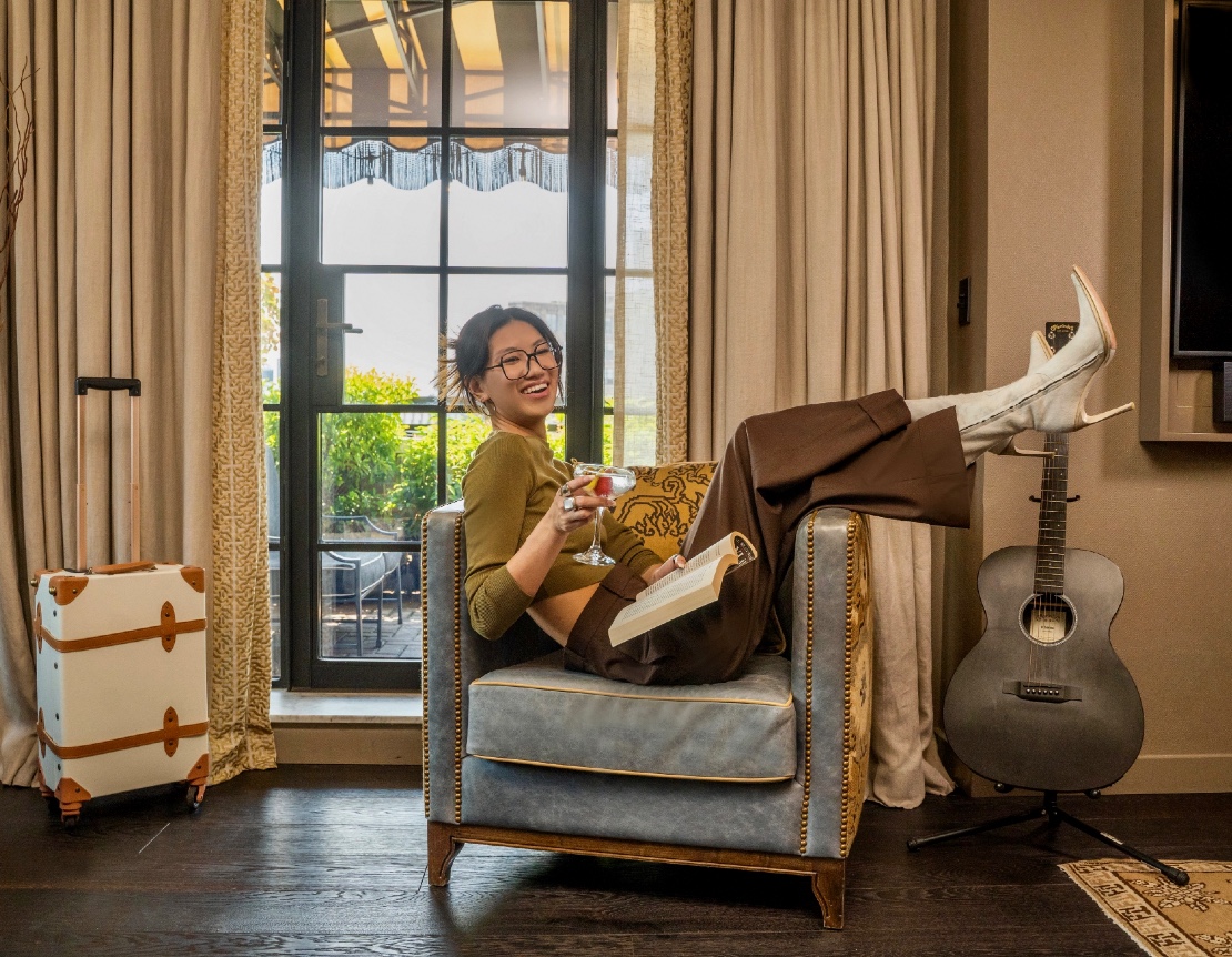 Woman sitting on chair while kicking up her heals.